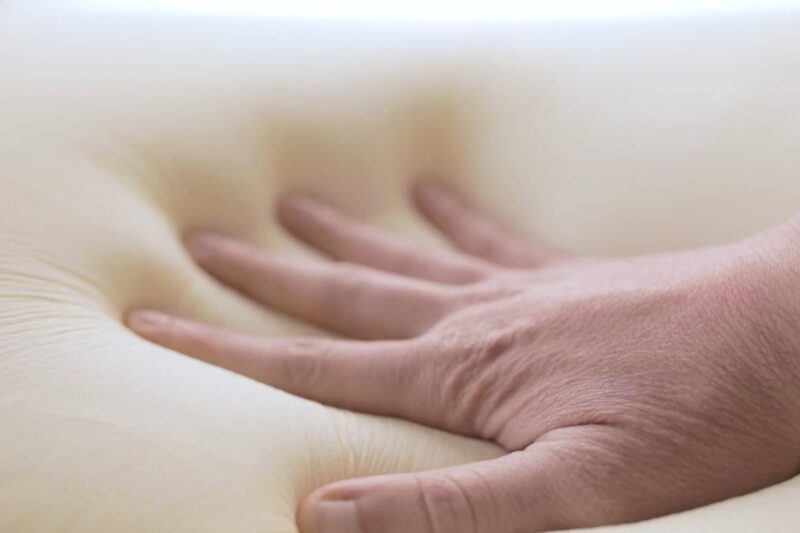 osoba proverava rukom tvrdoću dušeka